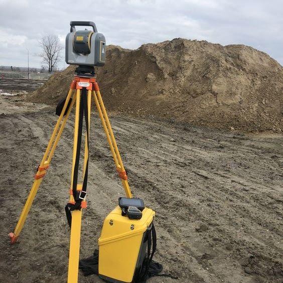 Total station beside a stockpile
